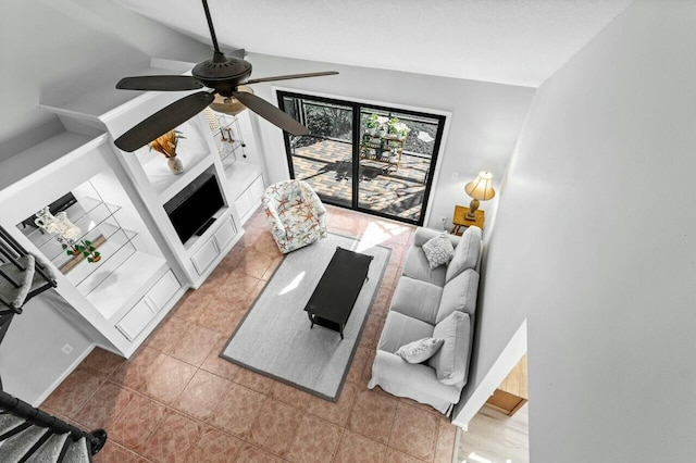 living room featuring ceiling fan, light tile patterned flooring, and lofted ceiling