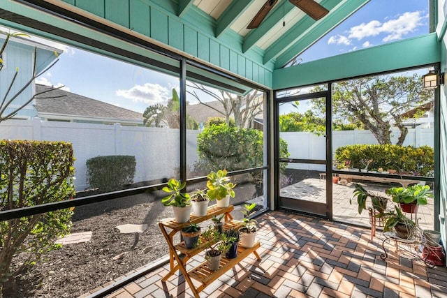 sunroom / solarium featuring vaulted ceiling