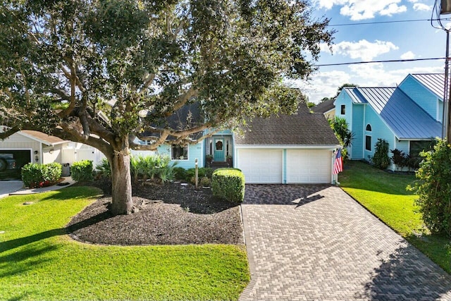 view of front of house featuring a garage and a front lawn