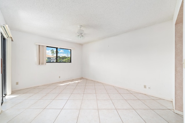 tiled spare room featuring ceiling fan and a textured ceiling