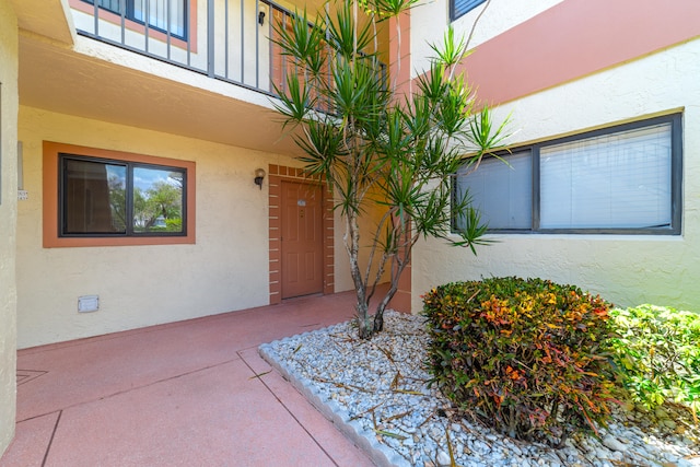 property entrance featuring a patio area