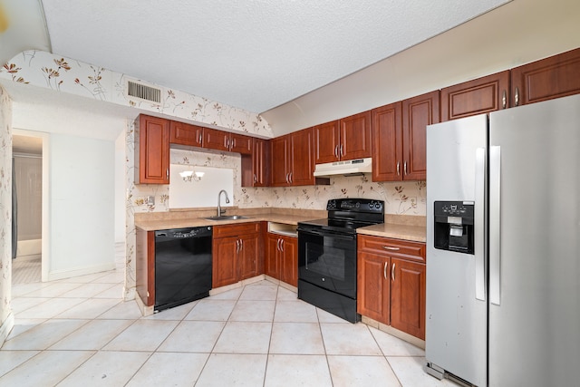 kitchen with light tile patterned floors, a textured ceiling, sink, and black appliances