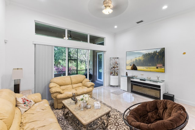 living room with crown molding and ceiling fan