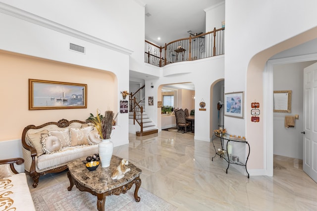 interior space featuring crown molding and a towering ceiling