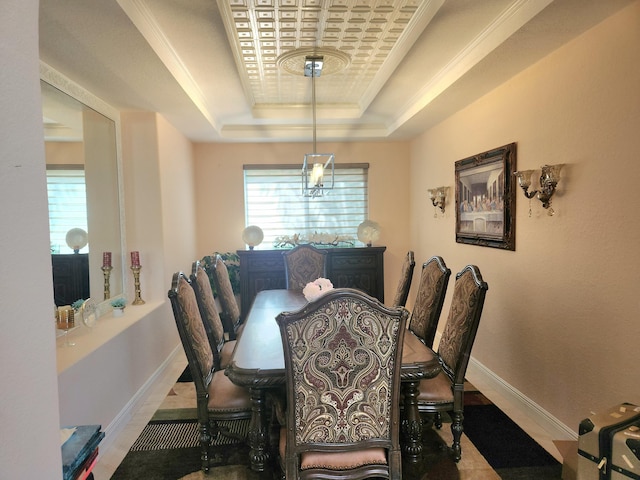 dining space with crown molding and a tray ceiling