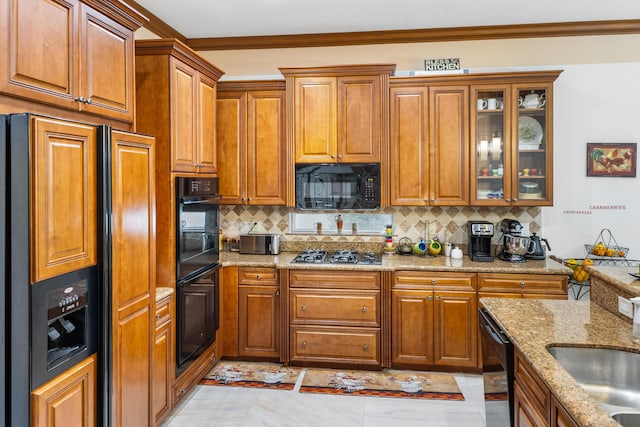 kitchen featuring backsplash, black appliances, sink, crown molding, and light stone counters