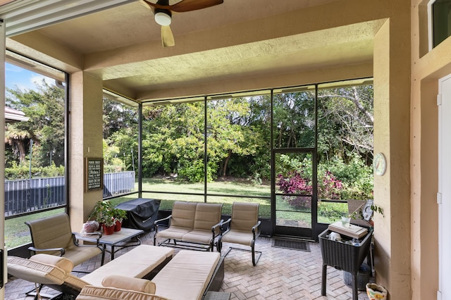 sunroom / solarium featuring ceiling fan and a healthy amount of sunlight