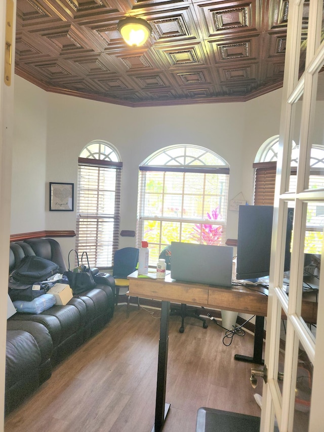 office with wood-type flooring, a wealth of natural light, and ornamental molding