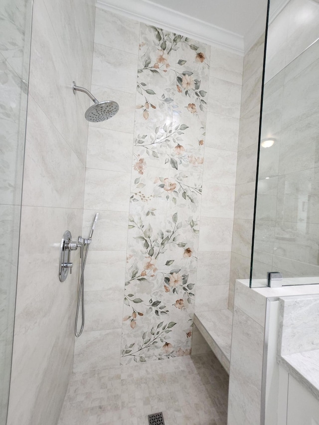 bathroom with a tile shower and ornamental molding