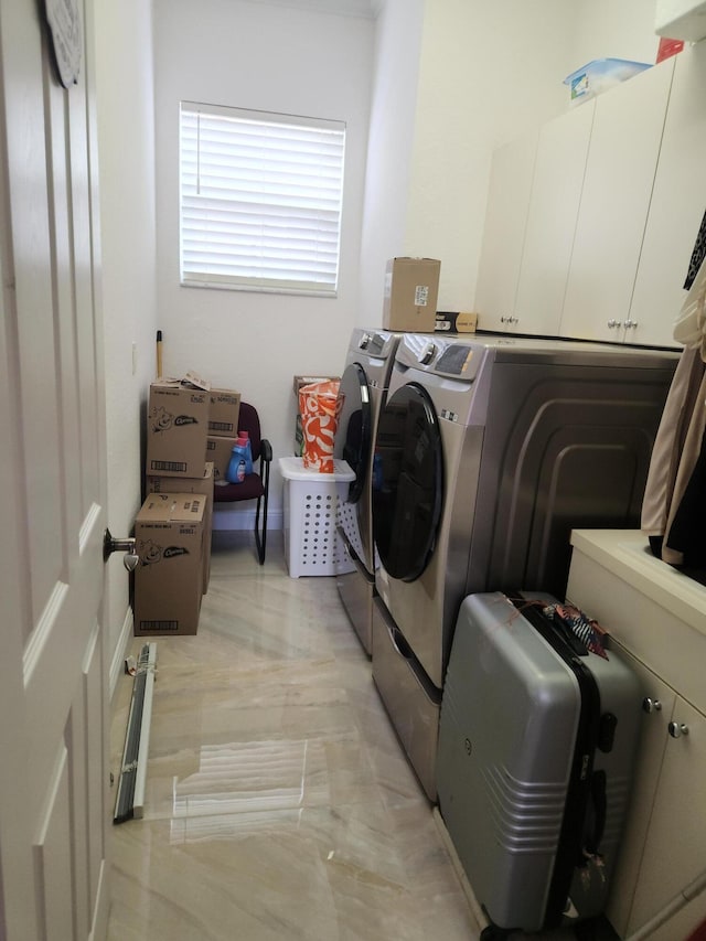 laundry room with cabinets and washer and clothes dryer