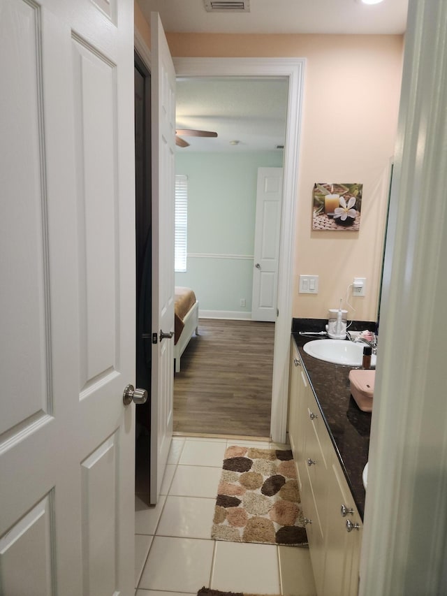 bathroom featuring hardwood / wood-style floors, vanity, and ceiling fan