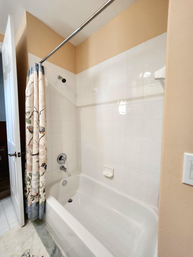 bathroom with tile patterned flooring and shower / bath combo with shower curtain