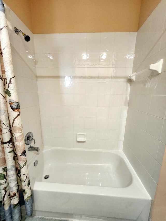 bathroom with shower / bath combination with curtain