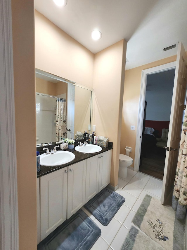 bathroom with tile patterned floors, vanity, toilet, and a shower with curtain