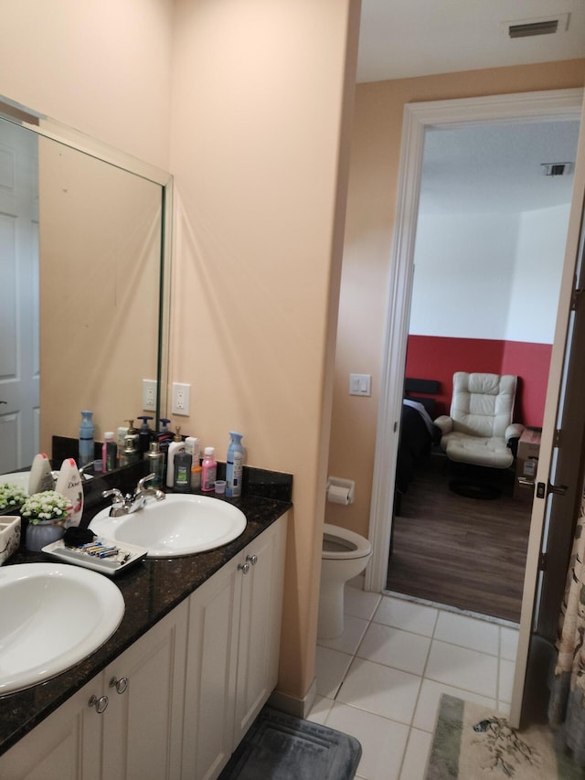 bathroom with tile patterned floors, vanity, and toilet