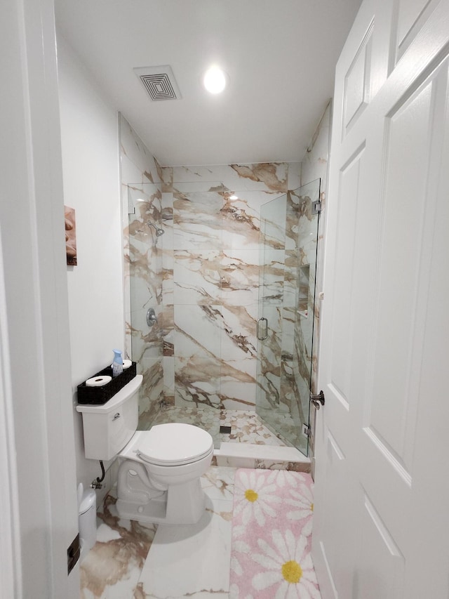 bathroom featuring toilet and an enclosed shower