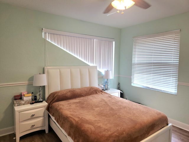 bedroom with ceiling fan and dark hardwood / wood-style floors