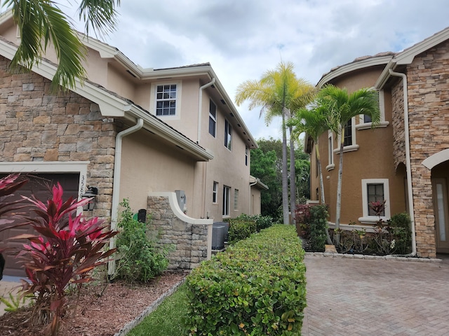 view of property exterior with central AC