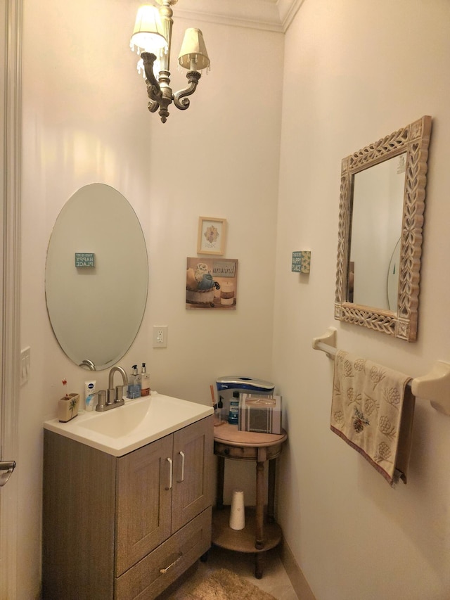 bathroom featuring vanity, ornamental molding, and a chandelier