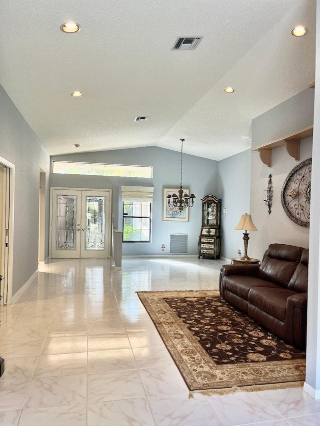 living room with french doors, a textured ceiling, a chandelier, and lofted ceiling