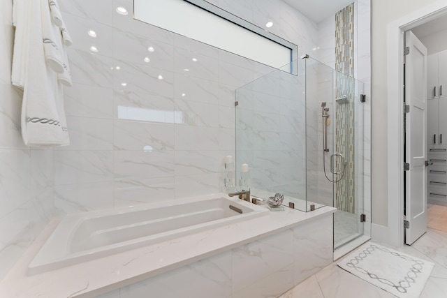 bathroom featuring separate shower and tub