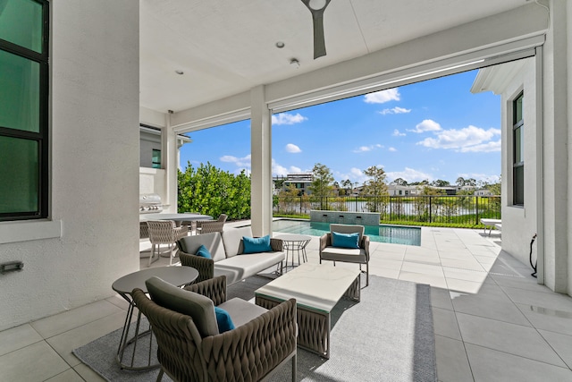 view of patio / terrace featuring a water view, an outdoor living space, and a fenced in pool