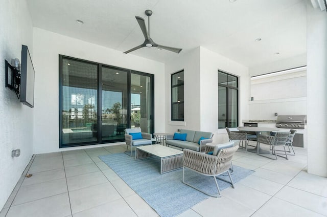 view of patio / terrace with exterior kitchen, an outdoor living space, ceiling fan, and grilling area