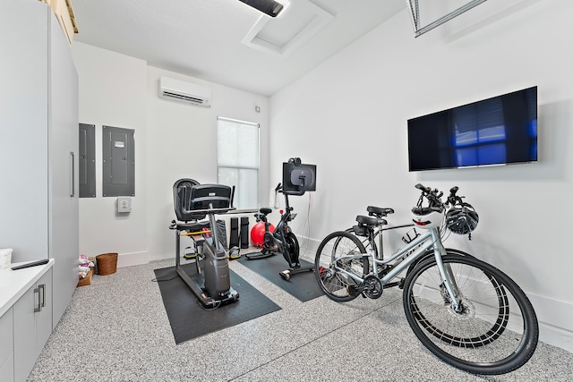 workout area with a wall unit AC and electric panel