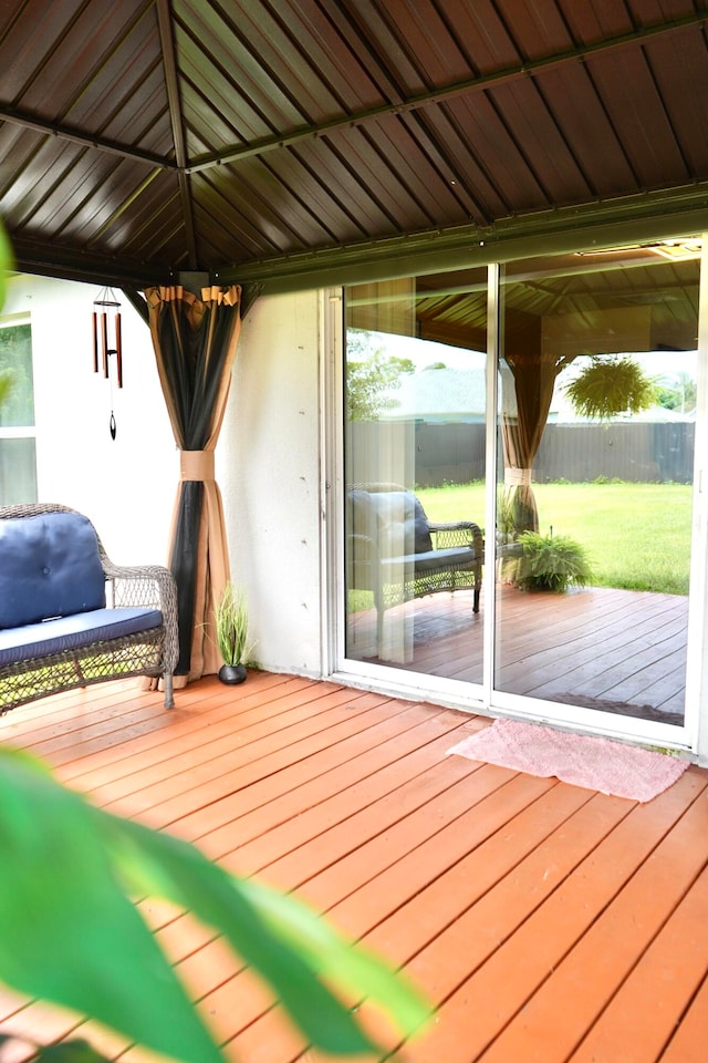 wooden terrace featuring a lawn