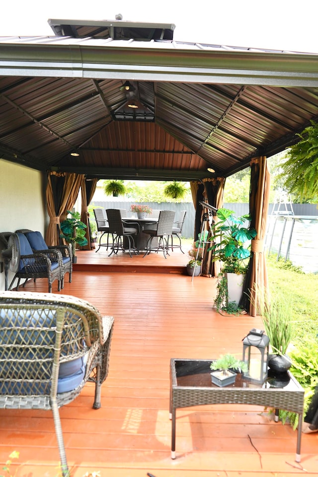 view of patio / terrace featuring a wooden deck and a gazebo