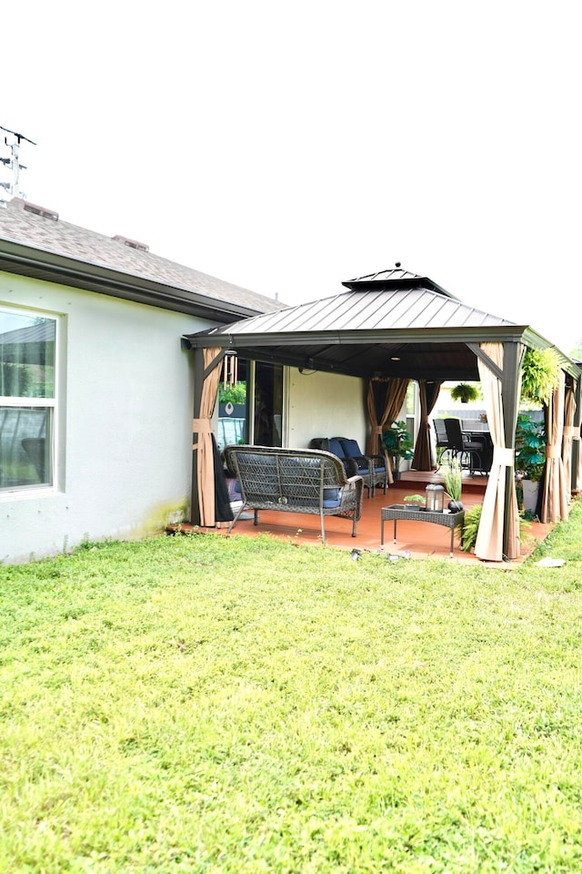 exterior space featuring an outdoor hangout area, a gazebo, and a lawn