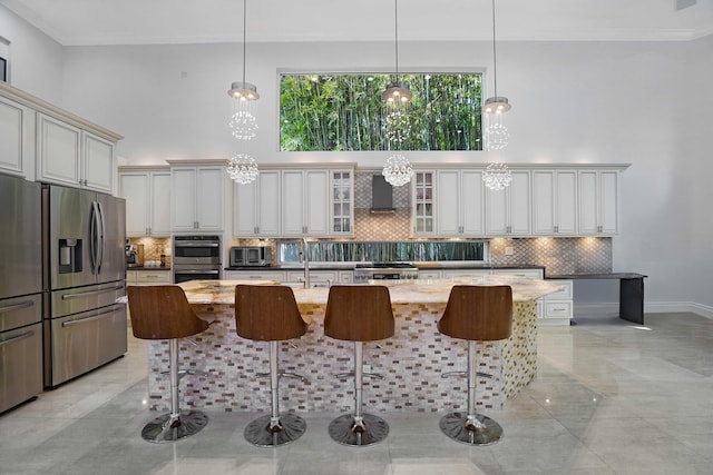 6595 NW 32nd Ter, Boca Raton, FL 33496 - kitchen featuring stainless steel appliances, wall chimney exhaust hood, tasteful backsplash, crown molding, and a high ceiling
