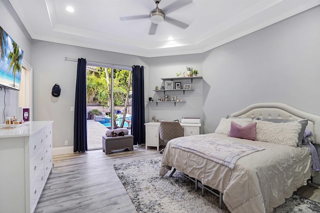 6595 NW 32nd Ter, Boca Raton, FL 33496 - bedroom with a raised ceiling, access to outside, wood finished floors, recessed lighting, and crown molding