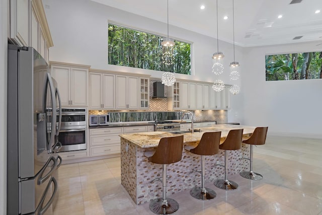 6595 NW 32nd Ter, Boca Raton, FL 33496 - kitchen with stainless steel appliances, a high ceiling, tasteful backsplash, a kitchen breakfast bar, and light stone counters