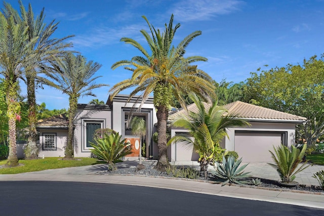 6595 NW 32nd Ter, Boca Raton, FL 33496 - view of front facade featuring an attached garage, stucco siding, and a tile roof