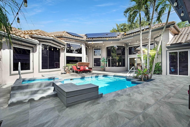 6595 NW 32nd Ter, Boca Raton, FL 33496 - rear view of property with solar panels, an in-ground hot tub, a patio, an outdoor pool, and a tile roof