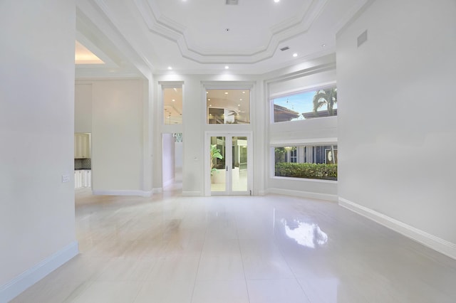 6595 NW 32nd Ter, Boca Raton, FL 33496 - unfurnished living room with a raised ceiling, ornamental molding, a high ceiling, french doors, and recessed lighting