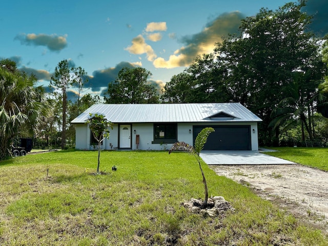 single story home with a front yard and a garage