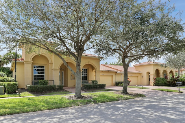 mediterranean / spanish-style home featuring a garage