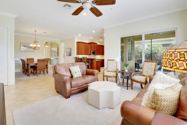 tiled living room featuring ceiling fan with notable chandelier and ornamental molding