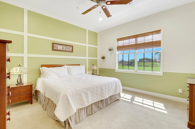 bedroom featuring light carpet and ceiling fan