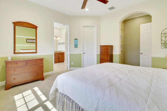 carpeted bedroom featuring ceiling fan and connected bathroom