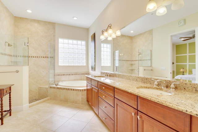 bathroom with ceiling fan, vanity, plus walk in shower, and tile patterned floors