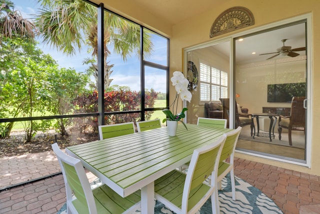 sunroom featuring ceiling fan