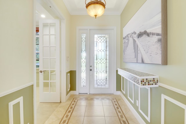 entrance foyer with crown molding and light tile patterned floors