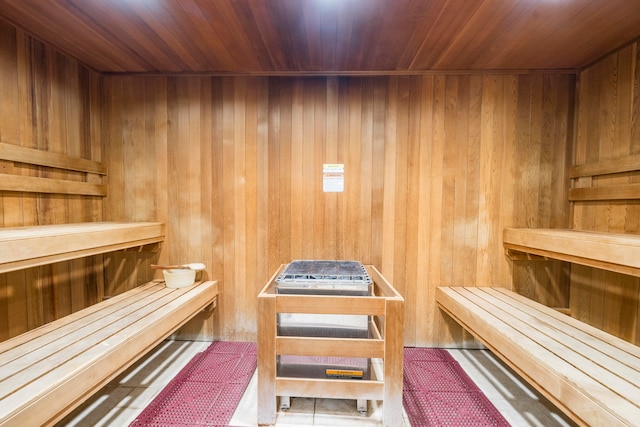 view of sauna / steam room featuring wooden ceiling and wood walls