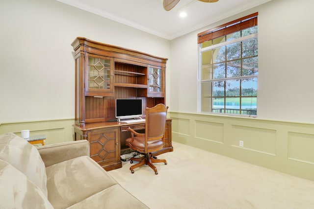 carpeted office featuring ceiling fan and ornamental molding