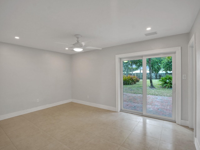 tiled empty room featuring ceiling fan