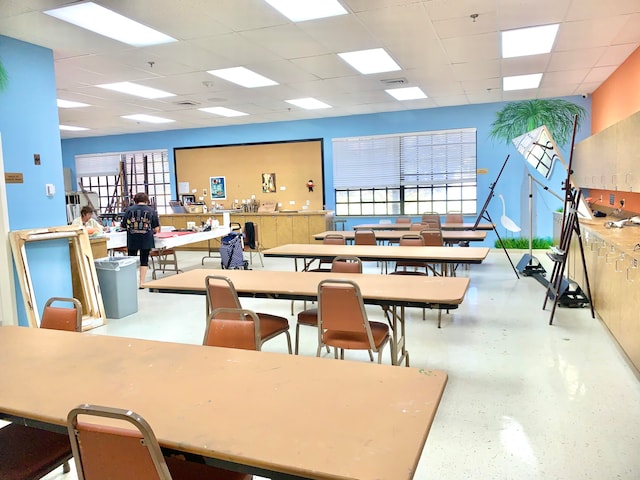 dining room with a paneled ceiling and a healthy amount of sunlight