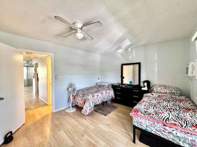 bedroom with hardwood / wood-style floors, a textured ceiling, and ceiling fan